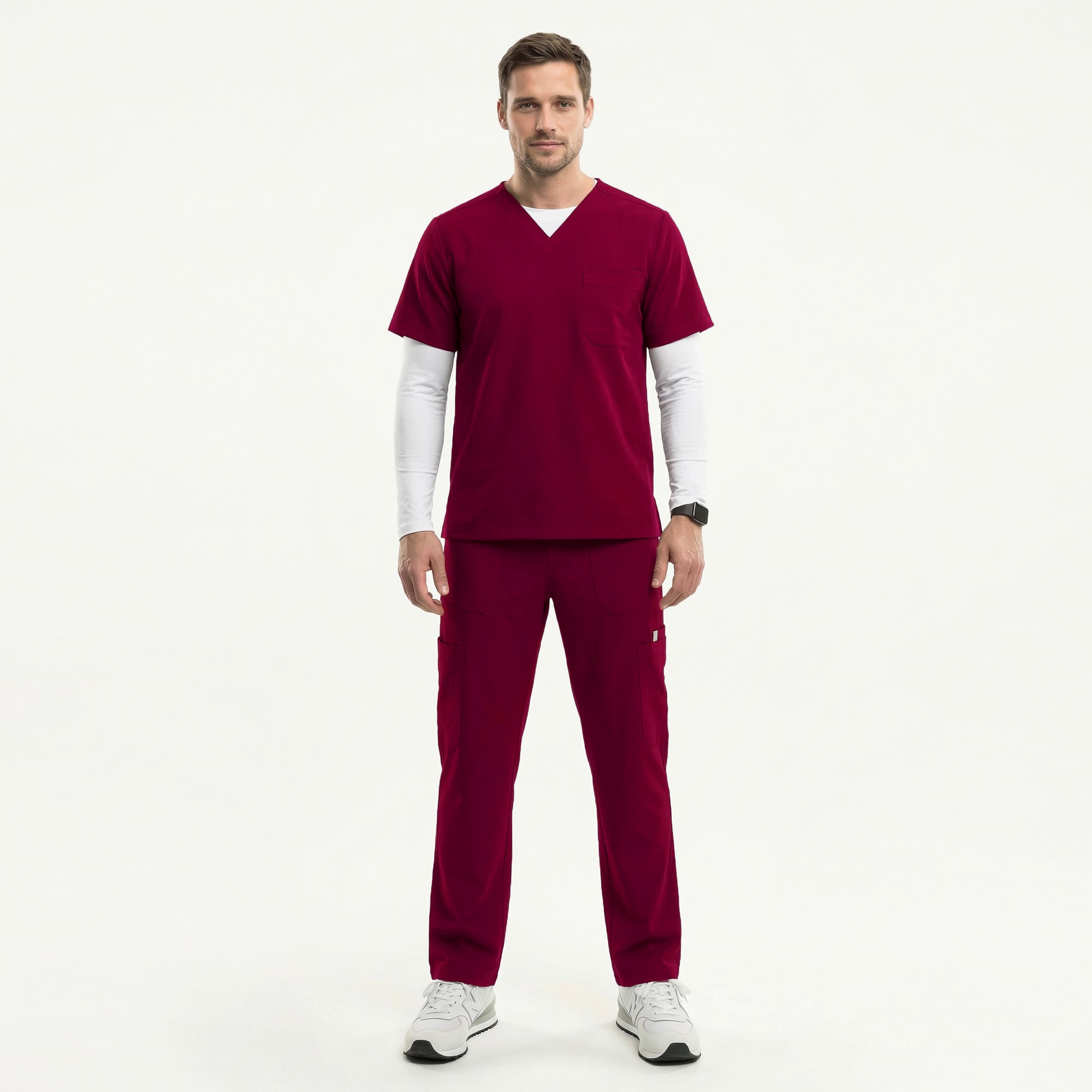 Image of Man wearing a burgundy V-neck scrub top layered over a white long-sleeve undershirt, paired with matching scrub pants and white sneakers,Burgundy