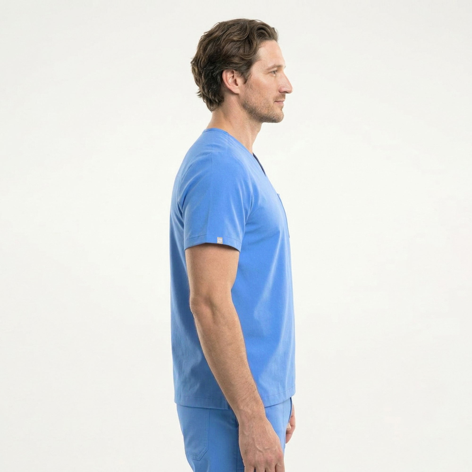Image of Male model wearing a ceil blue V-neck scrub set with a chest pocket holding a yellow pen, designed for a professional and clean medical uniform appearance,Ceil Blue