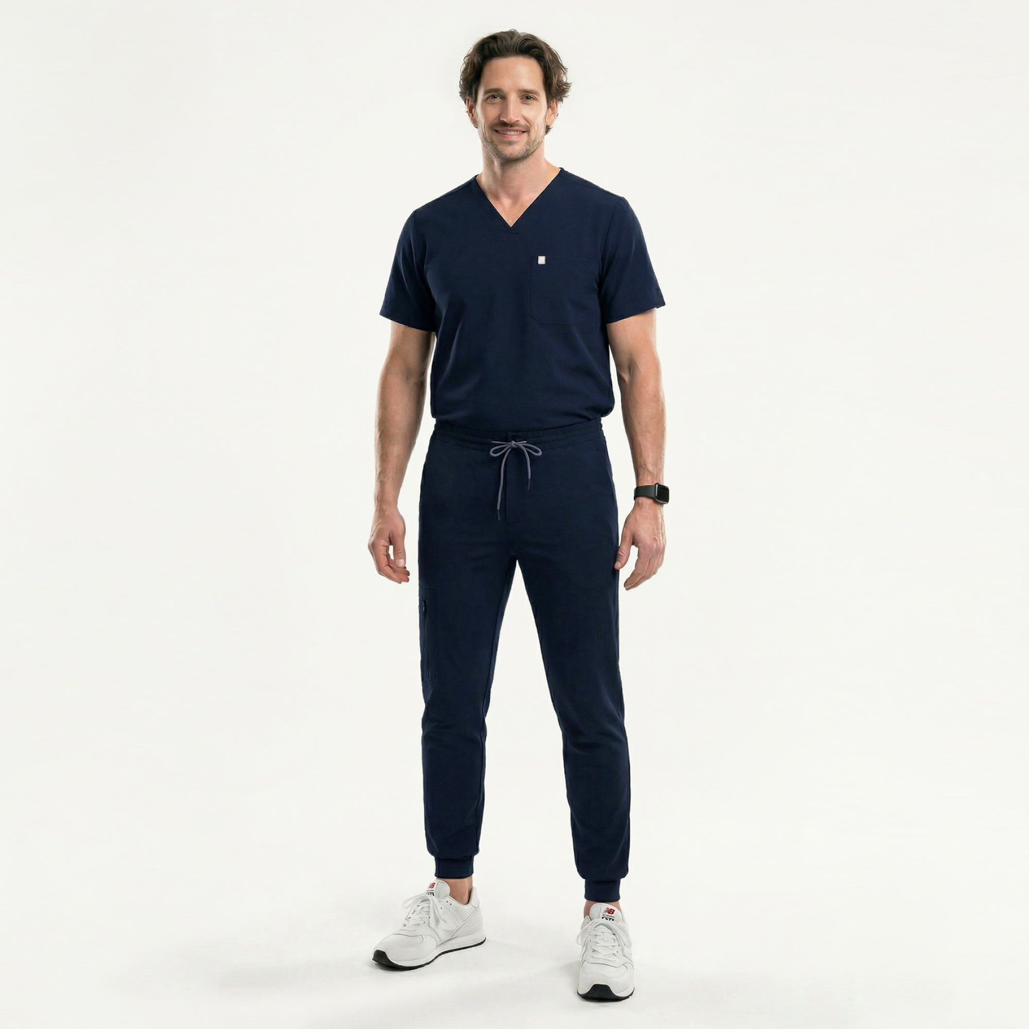 Image of Full-body view of a model in an Eco-Navy single-pocket scrub top and matching pants, highlighting the streamlined V-neck silhouette and lightweight performance fabric.
