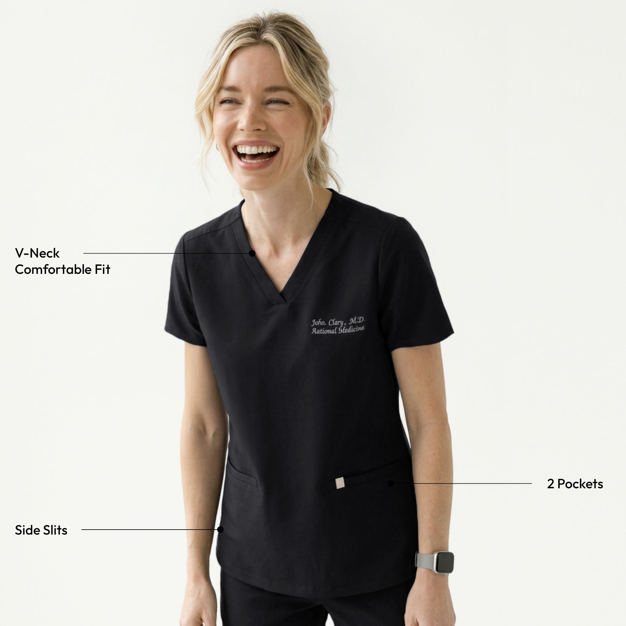 Image of Woman wearing a black V-neck scrub top with embroidered name and side pockets, looking to the side,Eco Black