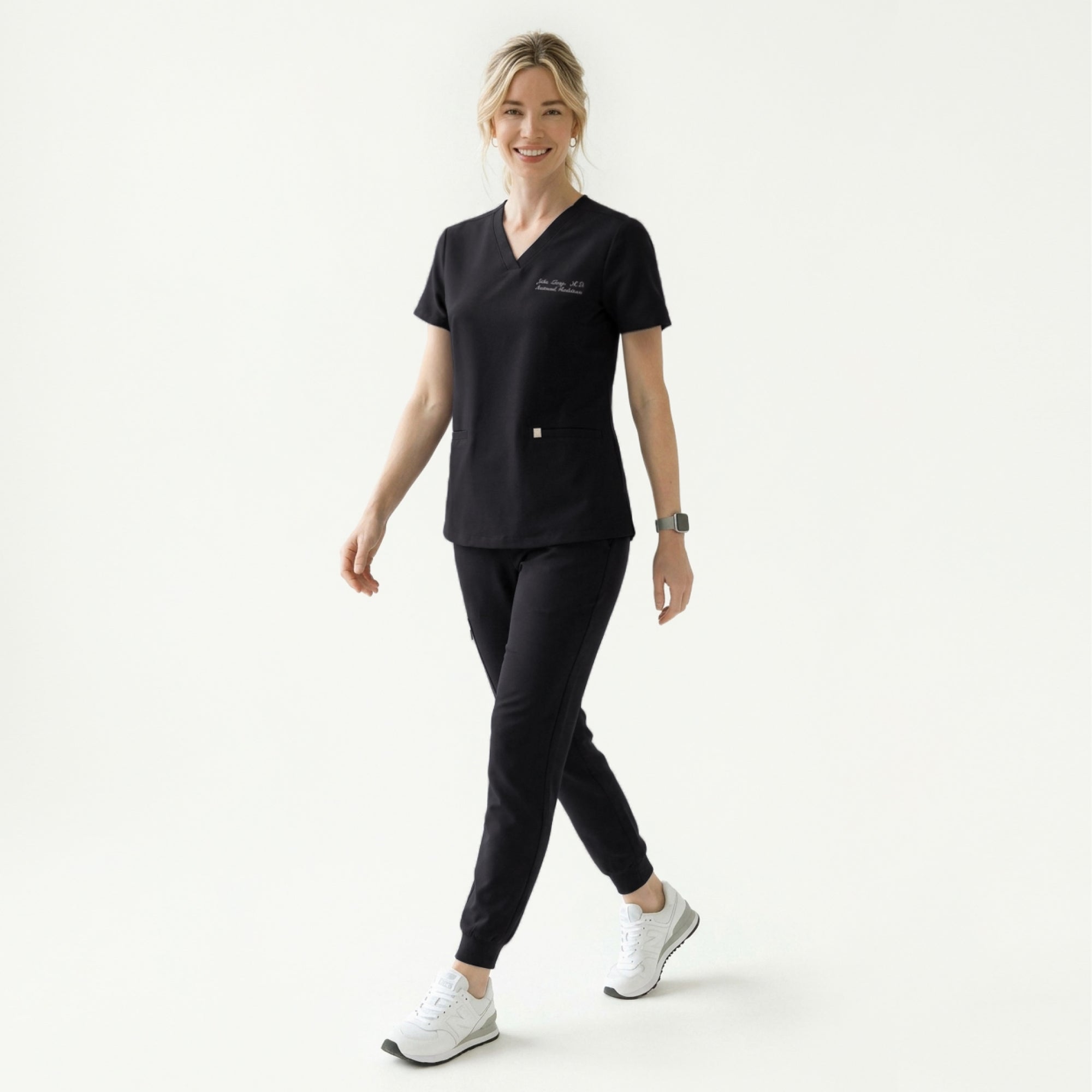 Image of Woman in a black scrub top holding a Zenir-branded mug, wearing a stethoscope and matching black scrub pants,Eco Black