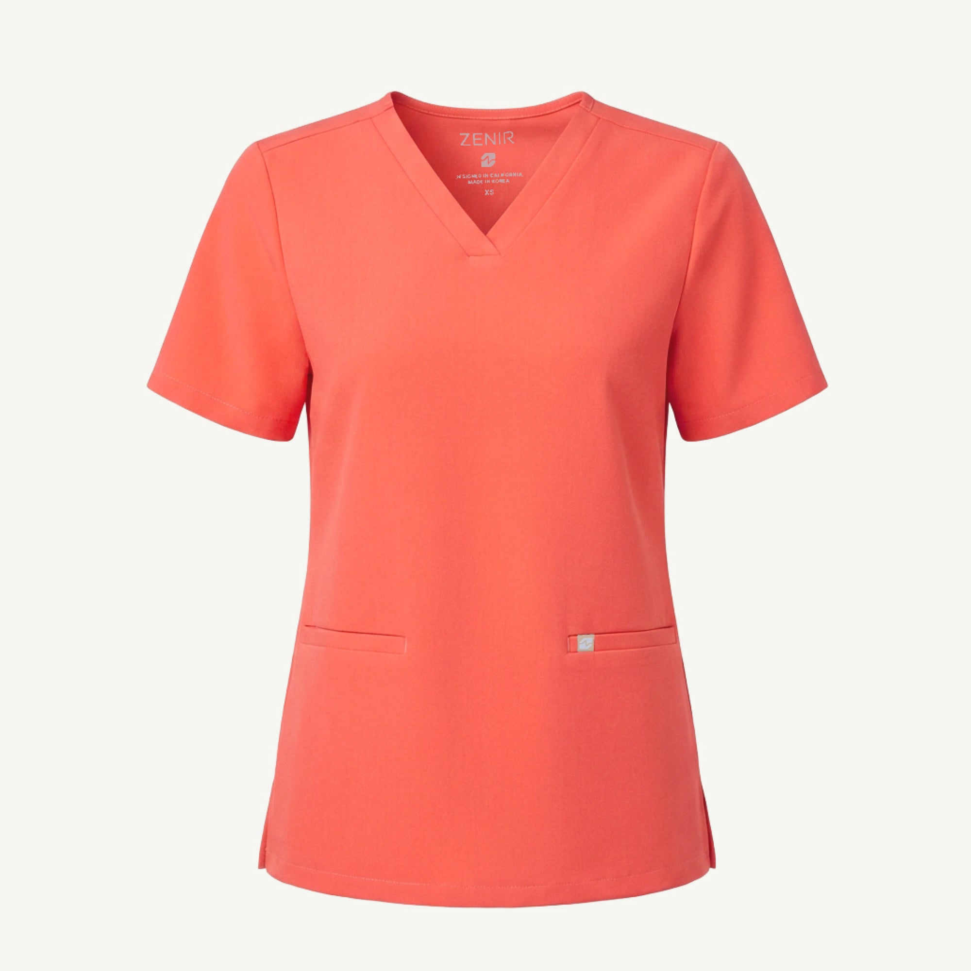 Image of Ghost mannequin image of a tiger-orange double-pocket scrub top on a white background