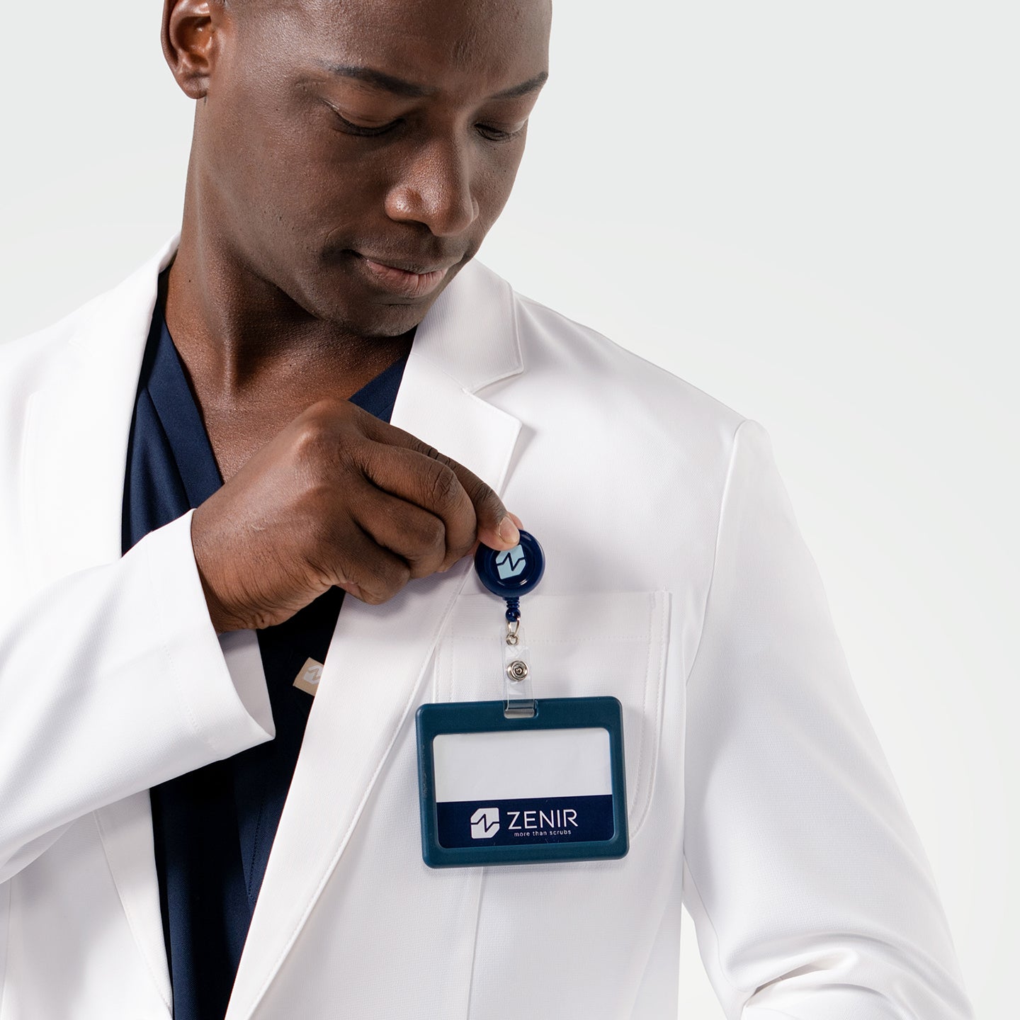 Image of A closer look at the Men’s LCM-100 Lab Coat shows its practical chest pocket with an ID badge clip.
