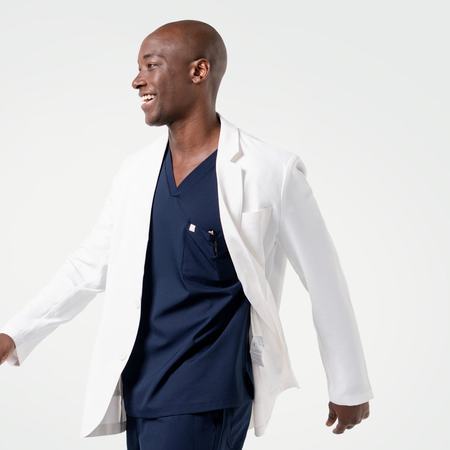 Image of Wearing the Men’s LCM-100 Lab Coat, the model is captured in motion with a bright smile.