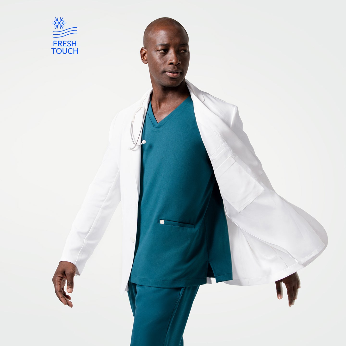Image of In motion wearing the Men's LCM-102 Lab Coat in White over medical scrubs, looking to the side with the coat flowing behind