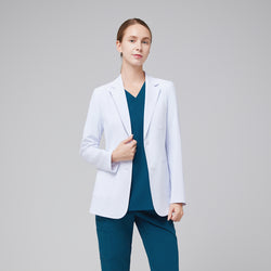 Image of Model facing forward wearing a white short lab coat, and blue scrub top and bottom under, with an expressionless facial expression,White