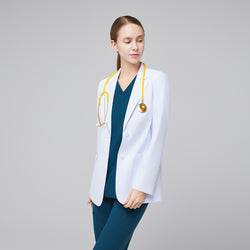Image of Model facing forward wearing a white short lab coat, blue scrub top and bottom, and a yellow stethoscope with her face turned sideways,White