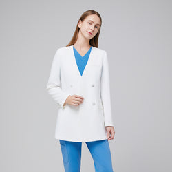 Image of Close-up front angle of a white double-breasted lab coat worn over a blue scrub set, highlighting the coat’s notched collar and button detailing,White