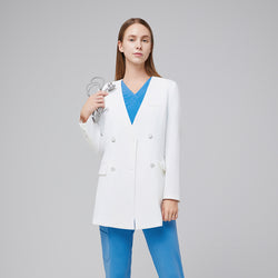 Image of Woman wearing a white double-breasted lab coat over a bright blue V-neck scrub top, holding a stethoscope,White