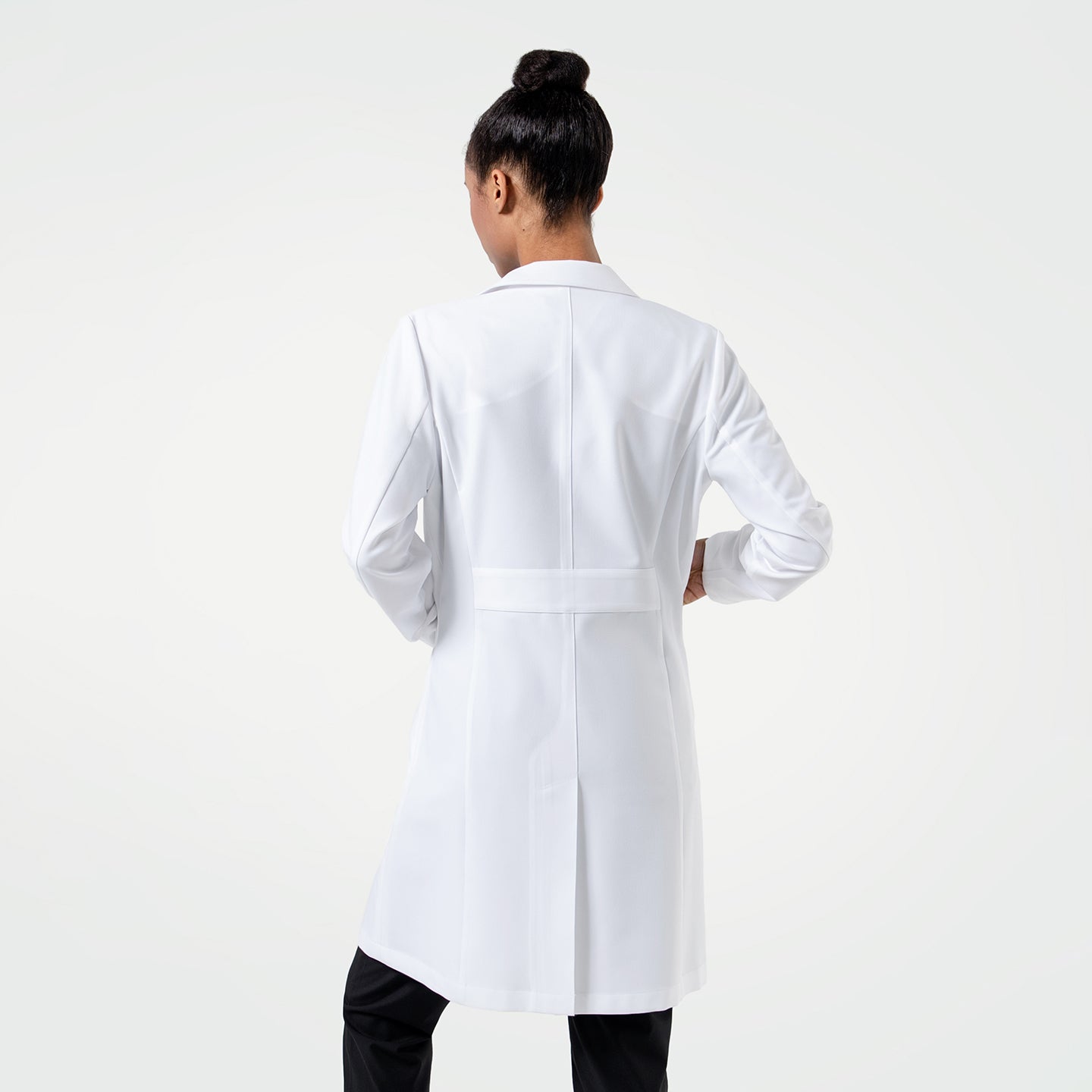 Image of Full body back view, Woman wearing the Women's LCW-102 Lab Coat in White over medical scrubs