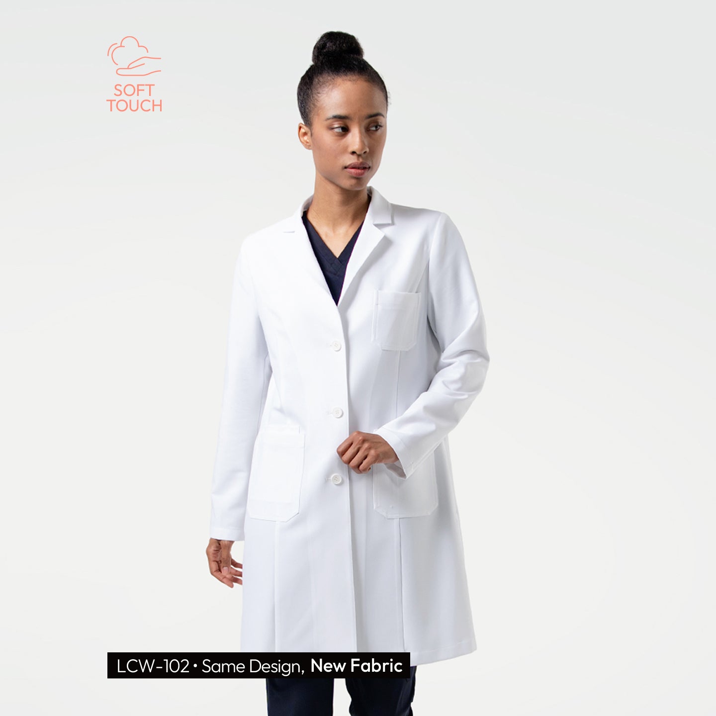 Image of LCW-203 Women’s white long lab coat featuring a tailored fit, three-button front closure, and spacious chest and hip pockets, worn over navy scrubs.