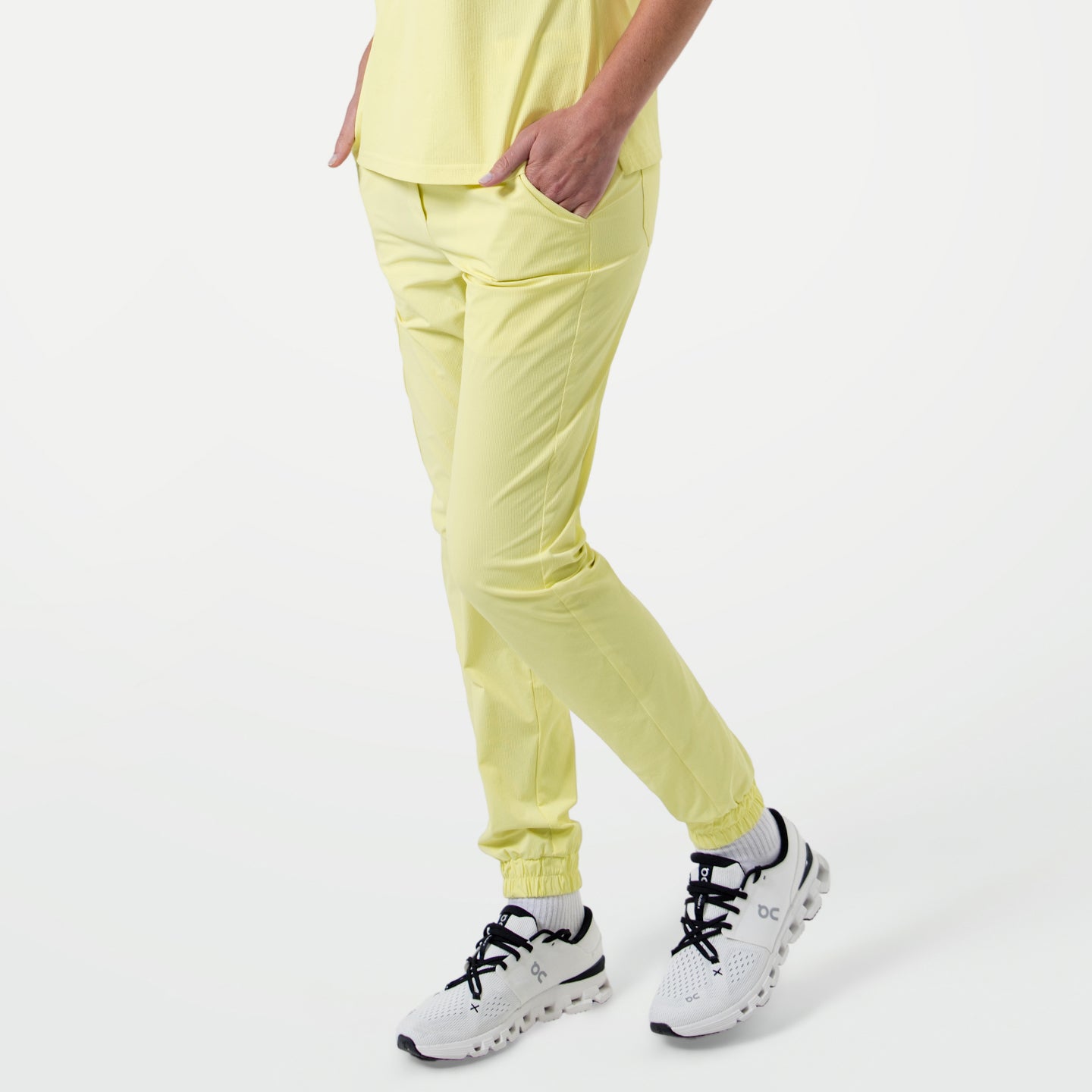 Image of Pineapple Yellow StretchFit jogger scrub pants shown in a side-angled view