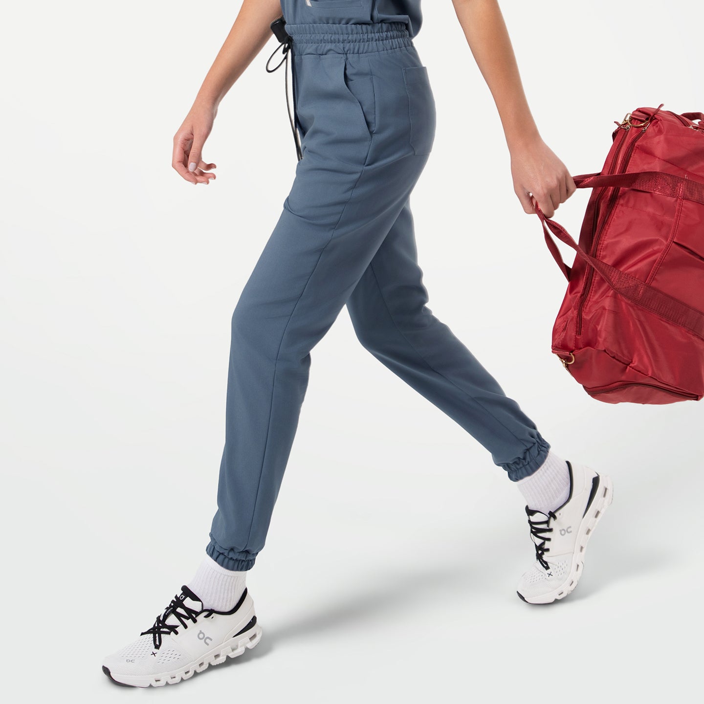Image of StretchFit jogger scrub pants in Smoky Blue, displayed from a side walking angle