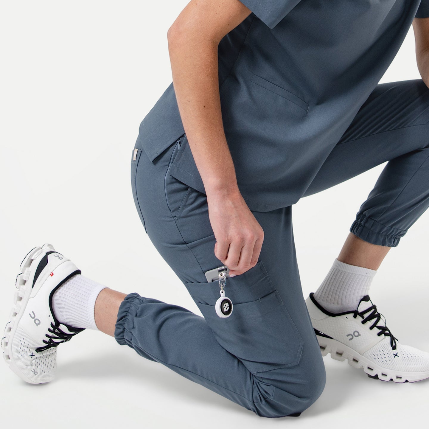StretchFit jogger scrub pants in Smoky Blue, shown in a kneeling pose