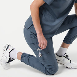 Image of StretchFit jogger scrub pants in Smoky Blue, shown in a kneeling pose