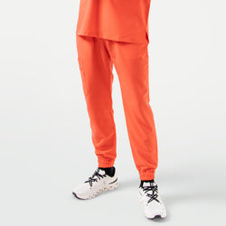 Image of Tiger Orange StretchFit jogger scrub pants in a front view, featuring an elastic waistband, cuffed hems, and a practical side cargo pocket.
