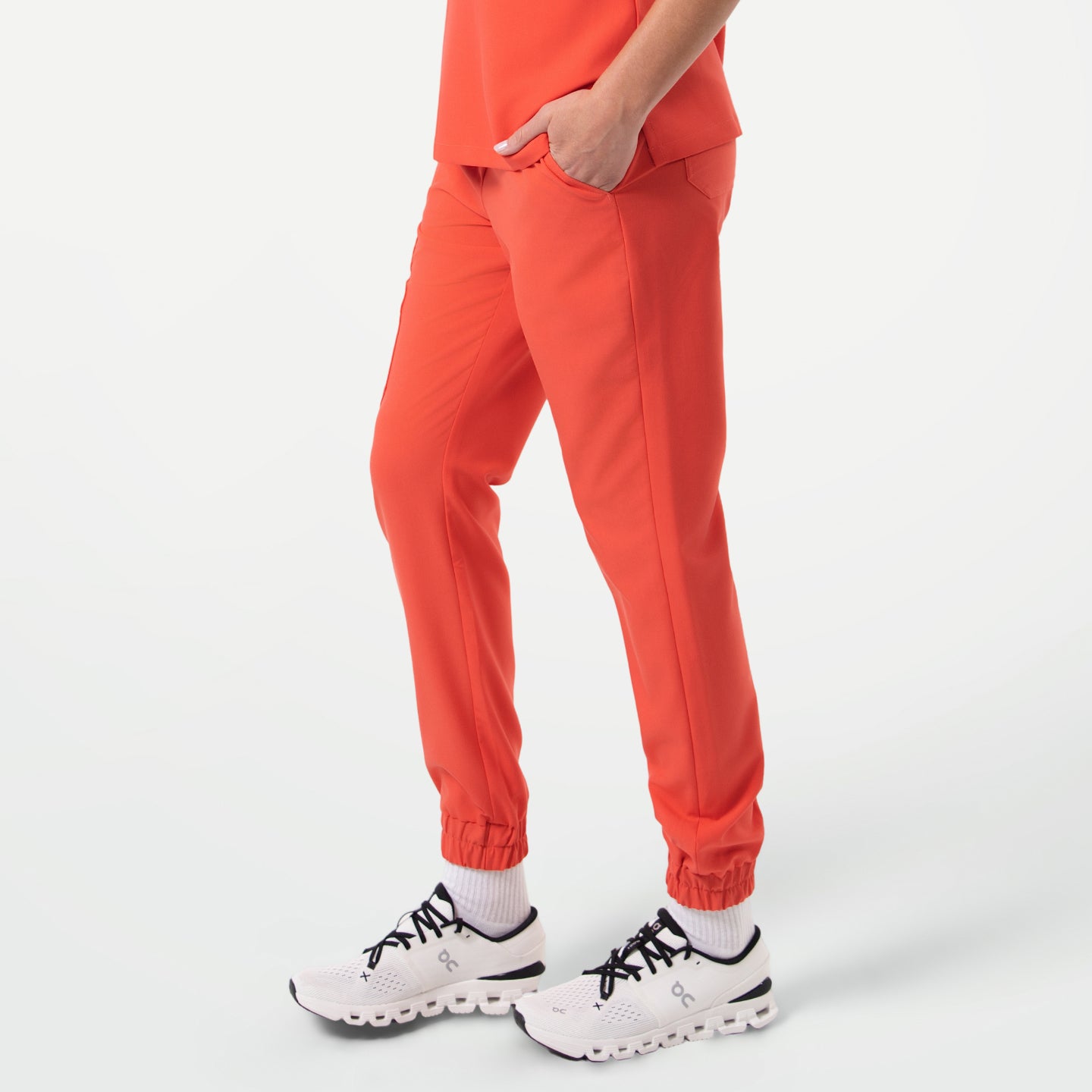 StretchFit Jogger Scrub Pants in Tiger Orange shown from a side angle.