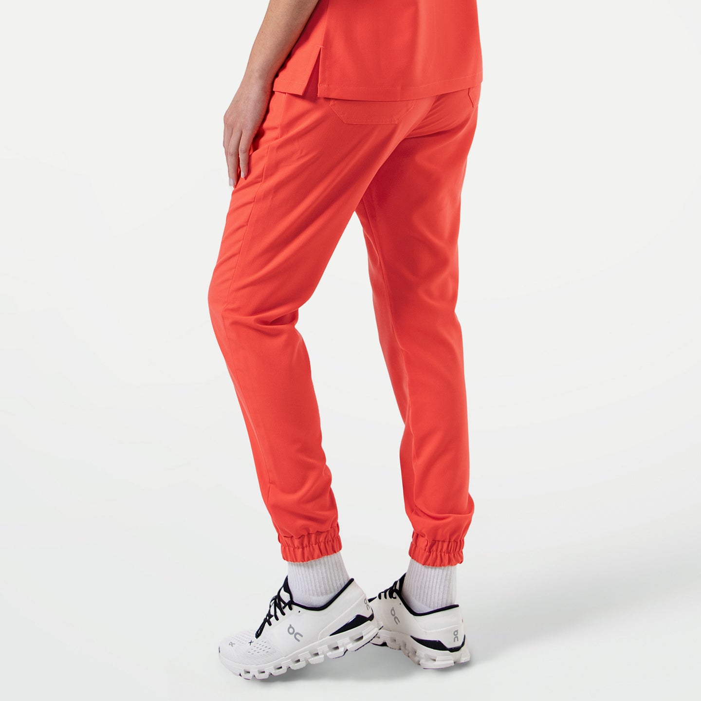 Image of StretchFit Jogger Scrub Pants in Tiger Orange, back angled view
