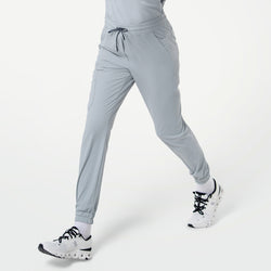 Image of Close-up of a person walking in StretchFit Jogger Scrub Pants in Cool Gray, showing the side pockets and drawstring waistband.