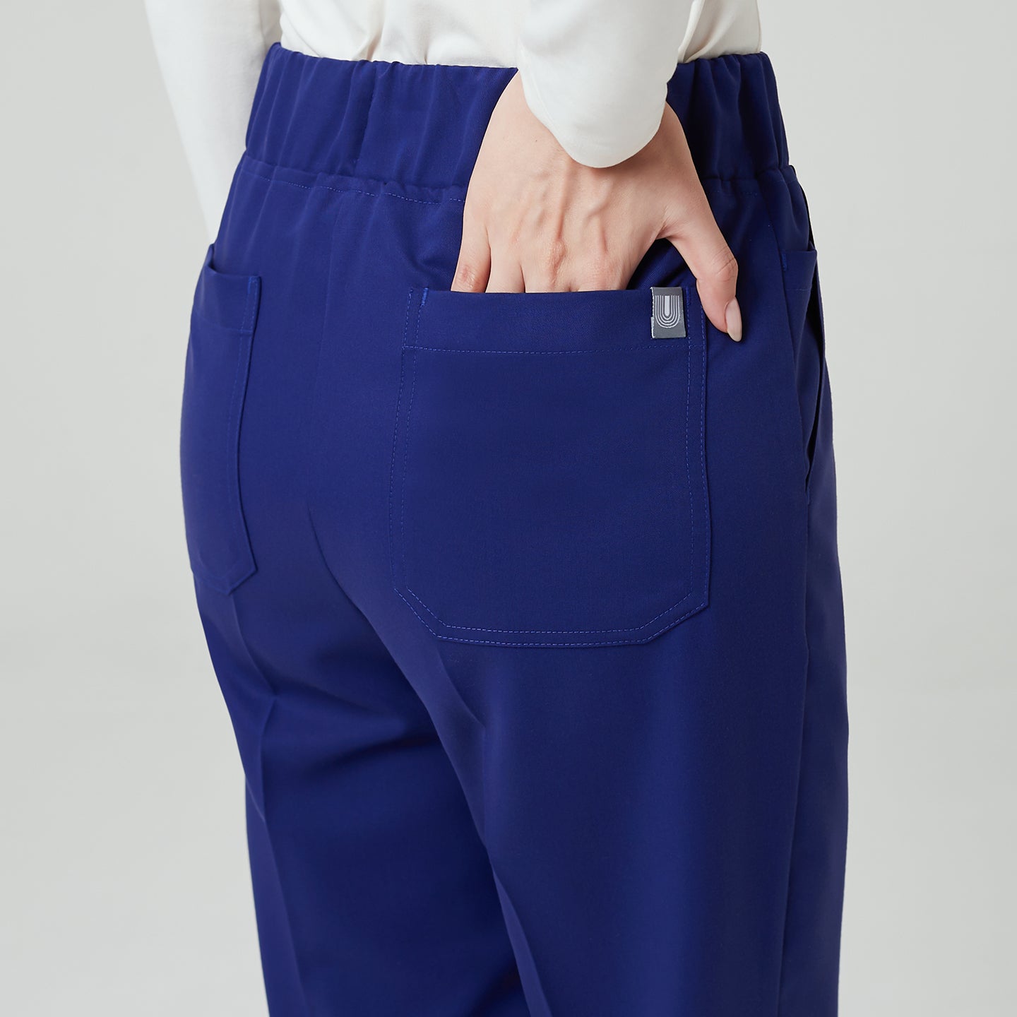 The Admiral Blue Pants feature a clean back design with functional patch pockets and a high-rise full-banding waist.