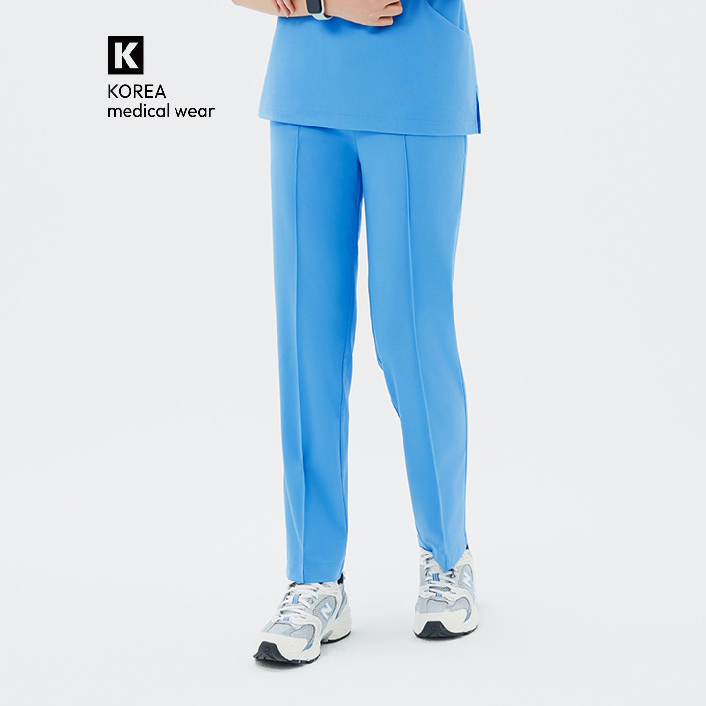 A front-facing look at the Aqua Blue Premium Banding Scrub Pants, showcasing their vivid blue tone and clean vertical seam lines.