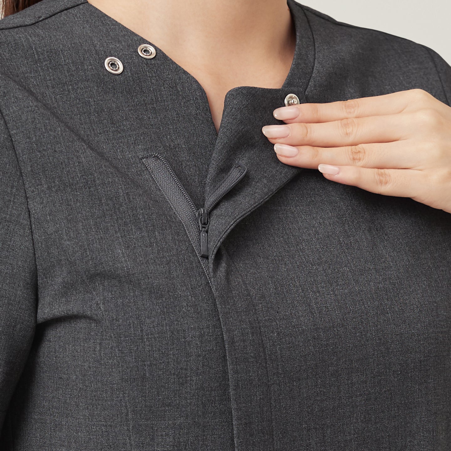 The Charcoal Gray OS-228 features a close-up of the hidden front zipper and snap closure, emphasizing its neat construction and easy wearability.