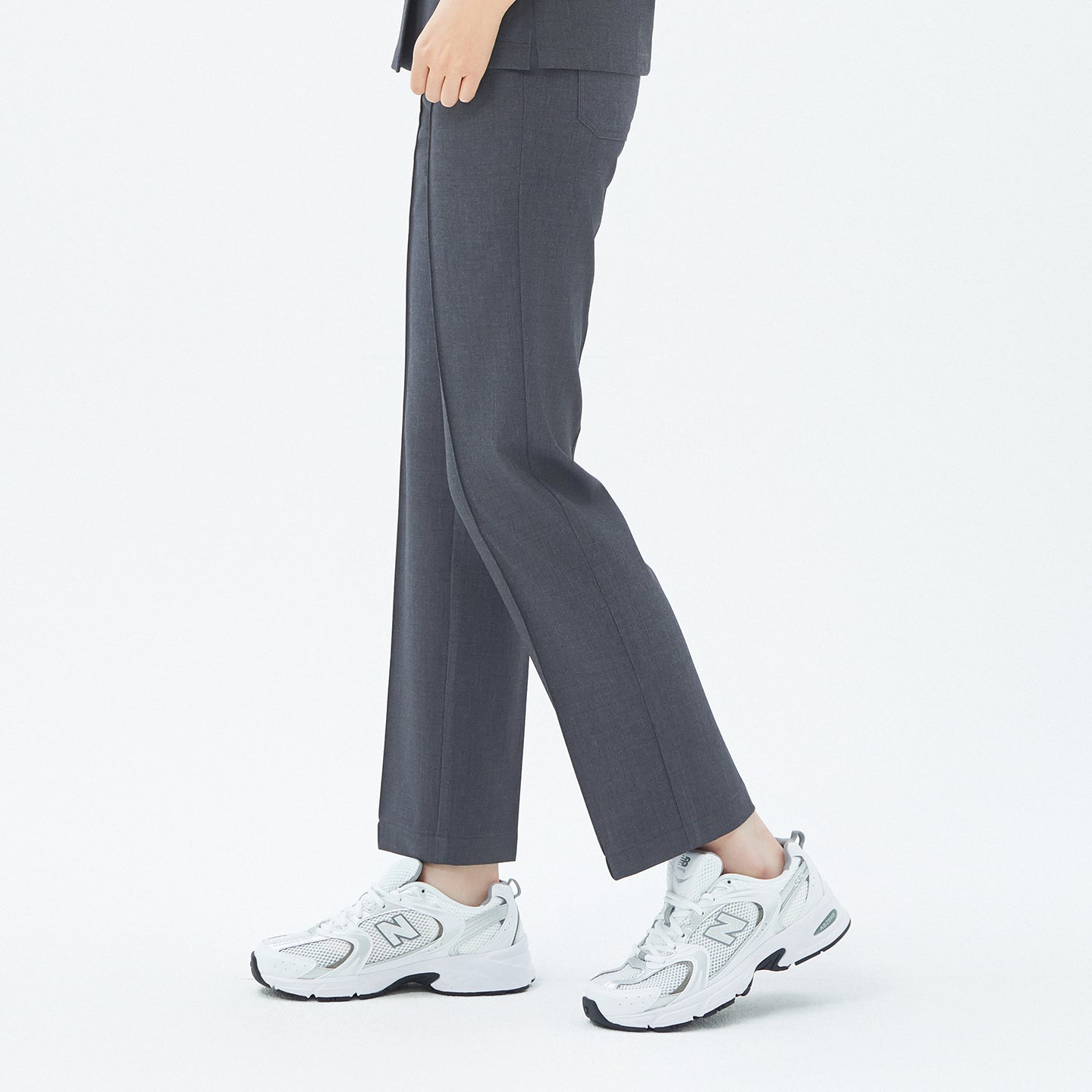 Image of The Charcoal Gray Premium Banding Scrub Pants present a straight-leg design with refined seam detailing, offering a crisp silhouette that maintains both comfort and structure.