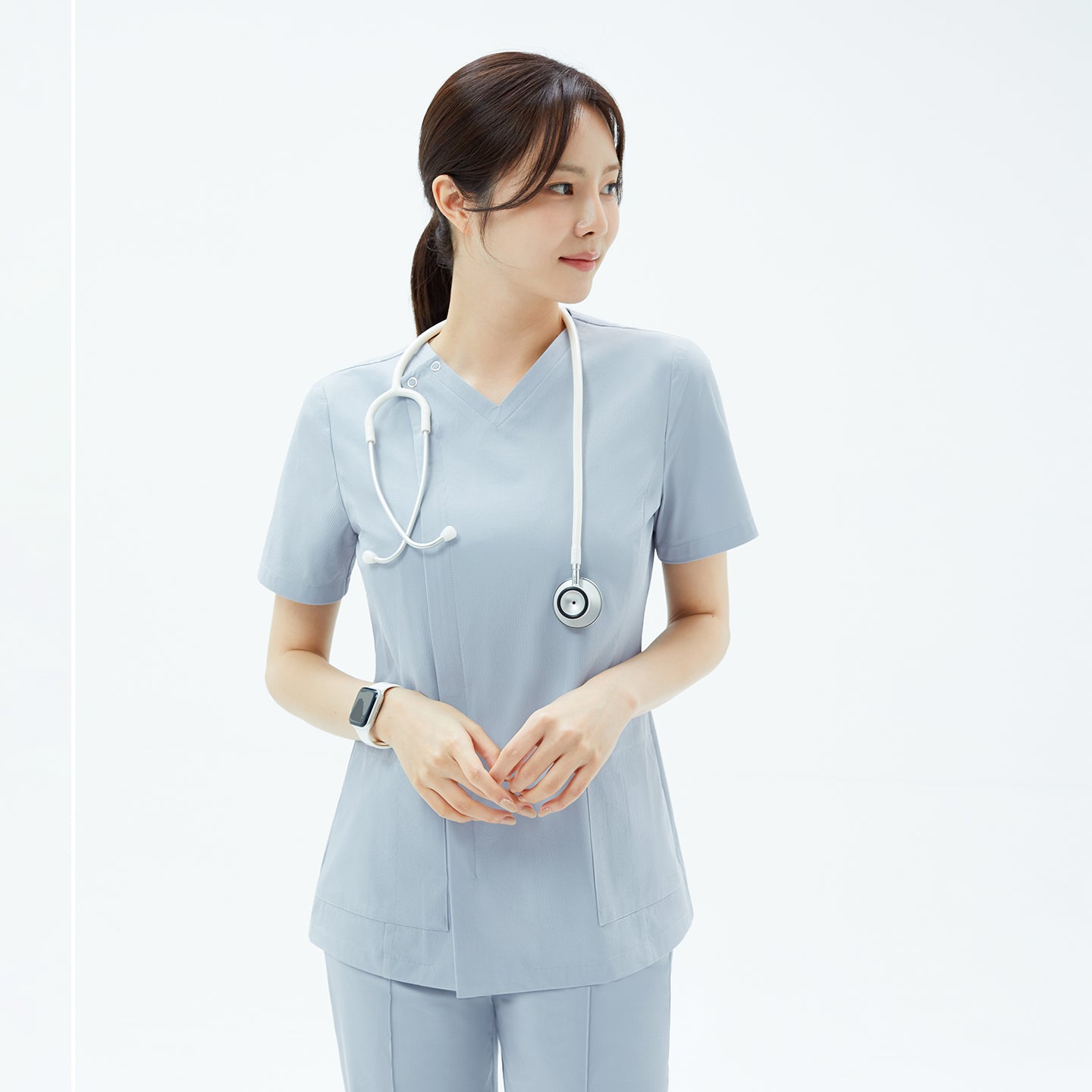 Image of The OS-224 in Cool Gray features a minimalist V-neck design with subtle front panel detailing, creating a refined and confident look suitable for modern medical professionals.