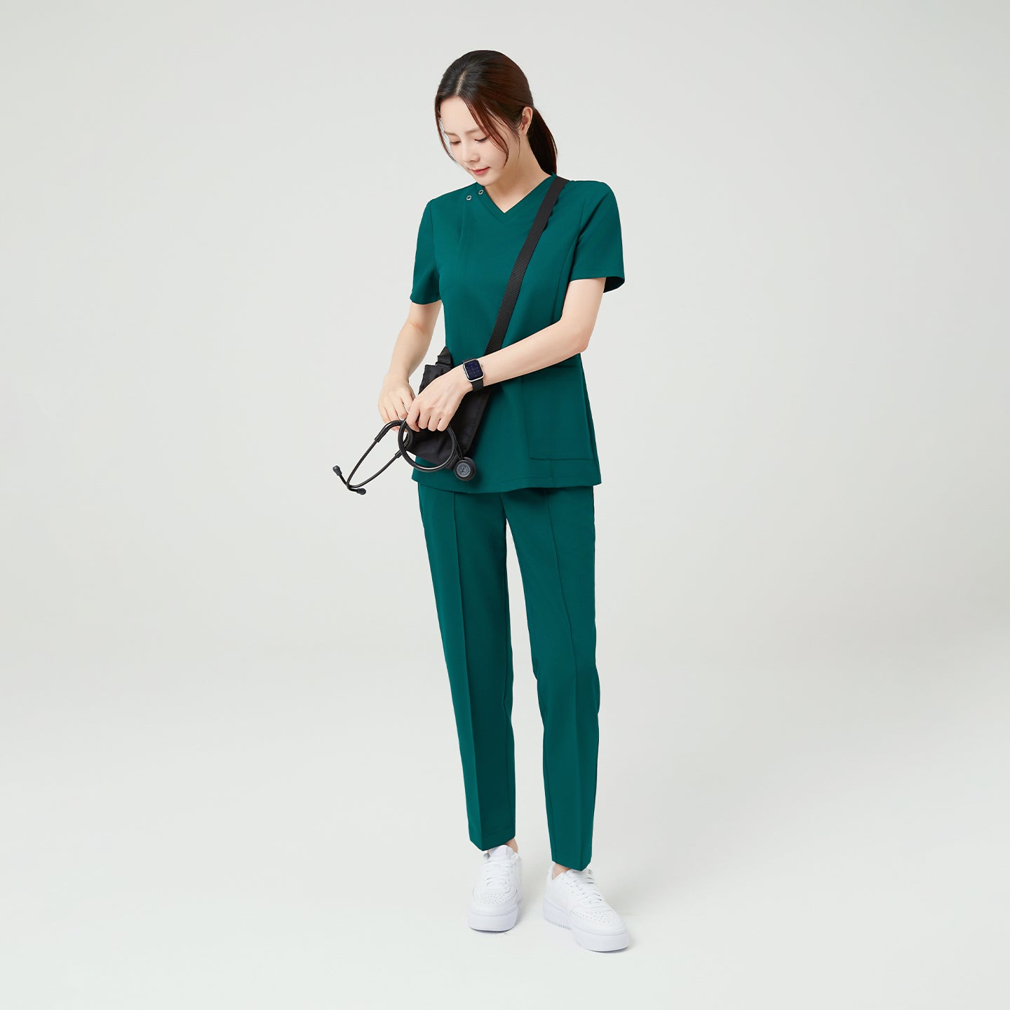 The Pine Green OS-225 scrub set showcases a modern, composed look with its rich green hue and clean tailoring. The structured V-neck and straight-leg for everyday comfort, ideal for active medical environments.