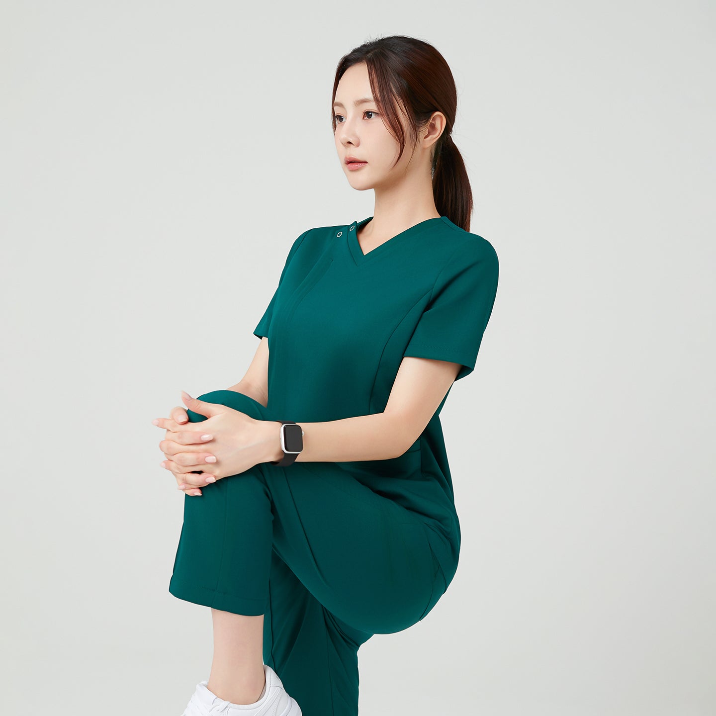 Image of With its flexible stretch fabric, the Pine Green OS-225 scrub top moves naturally with your body. The ergonomic fit ensures comfort even during active movement, making it ideal for professionals who value both functionality and a clean, modern look.