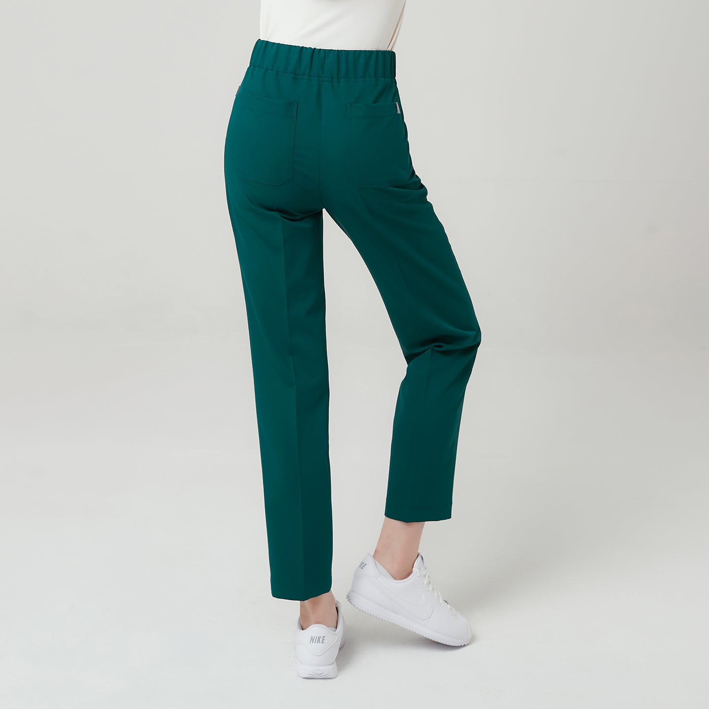 Image of Featuring a comfortable elastic waistband and practical rear pockets, the Pine Green Premium Banding Scrub Pants combine functionality with modern tailoring.