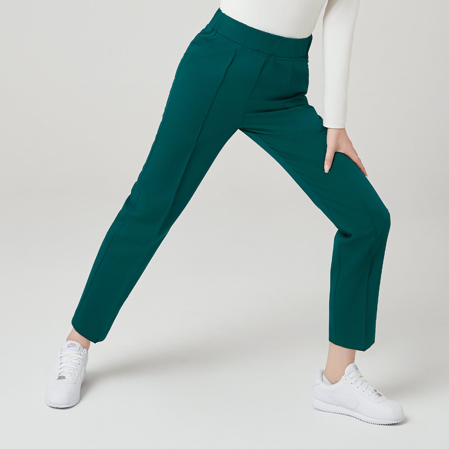 This shot highlights the Pine Green Premium Banding Scrub Pants exceptional stretch and mobility.