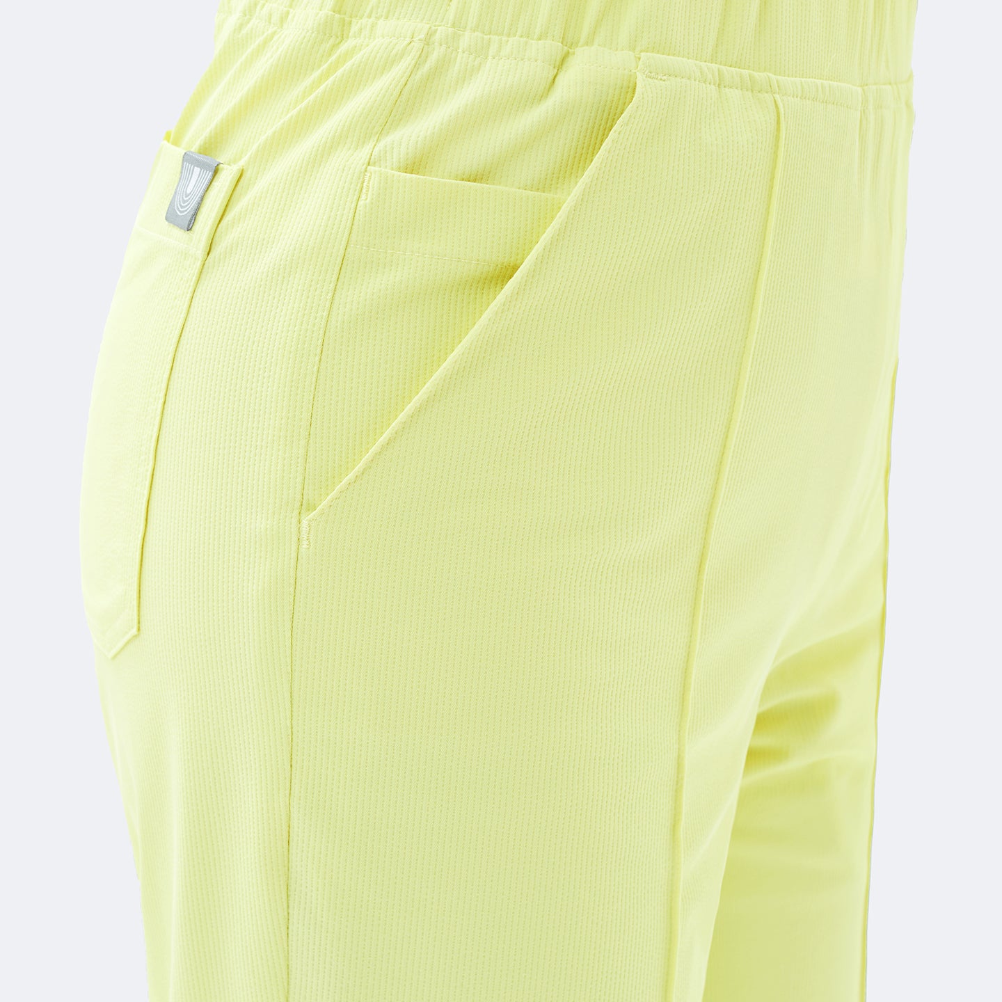 Image of Close-up of the Pine Yellow Premium Banding Scrub Pants highlighting the diagonal front pocket design.