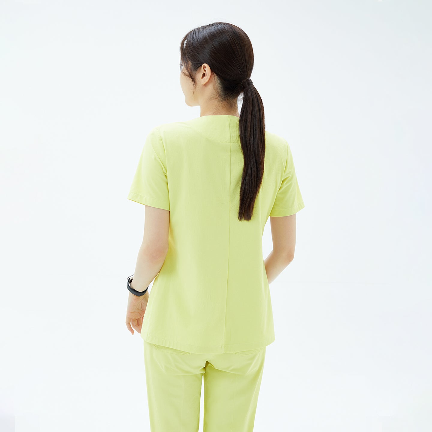 Pineapple Yellow OS-223 Scrub Top back view — designed with a clean center seam and a relaxed fit for smooth movement and a polished silhouette.