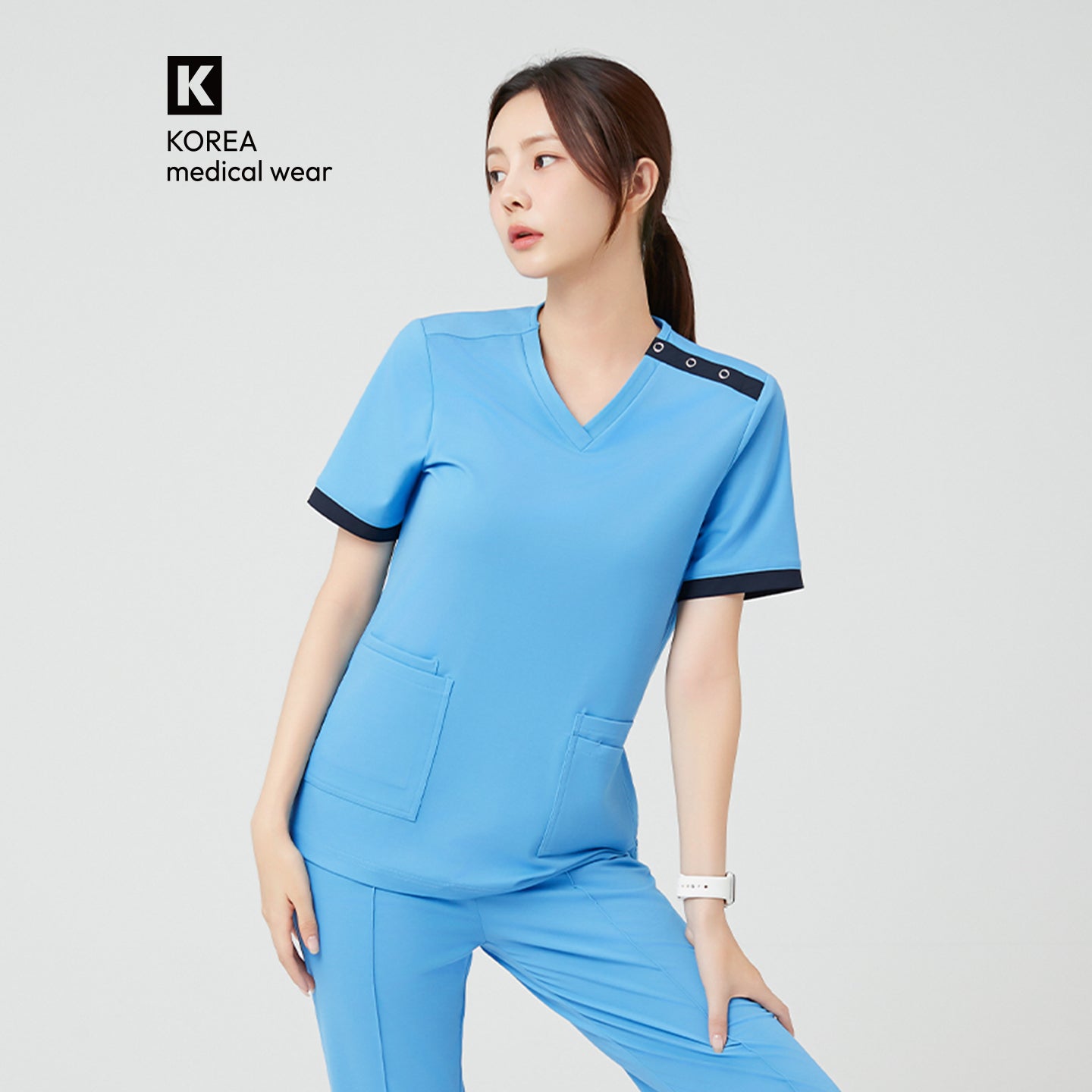 Image of The Sky Blue OS-231 scrub showcases a crisp, professional tone with a subtle contrast trim.
The structured V-neck and clean shoulder line enhance posture while maintaining a refined, modern aesthetic.