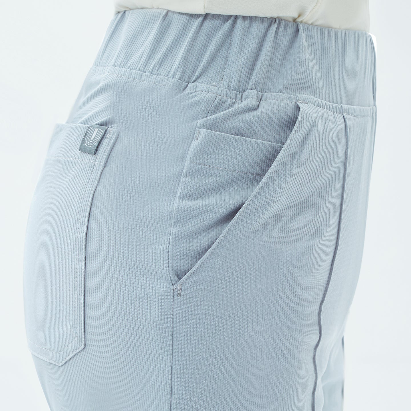 Image of Close-up of the Smoky Blue Premium Banding Scrub Pants reveals fine ribbed texture and neatly stitched pockets, combining functionality with subtle sophistication.