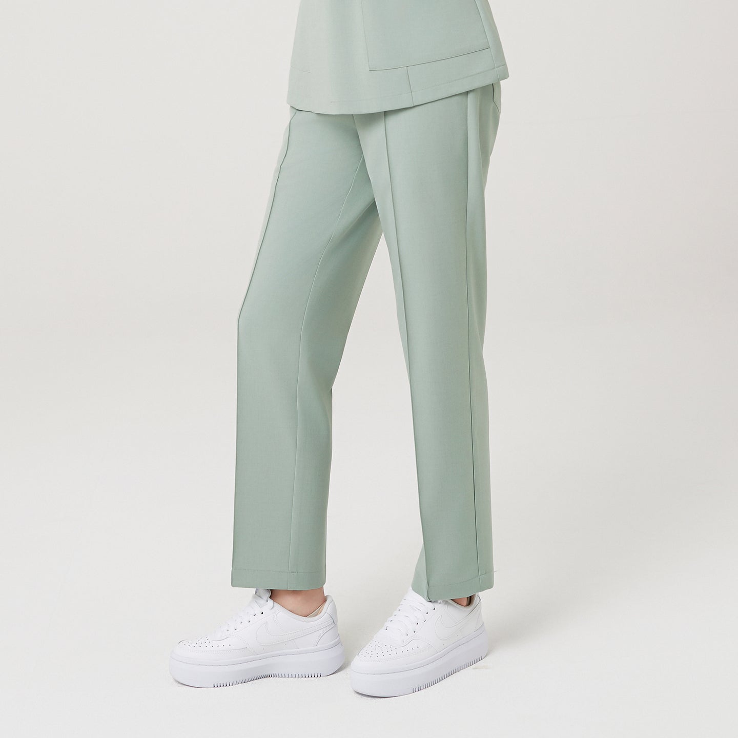 Image of The Soft Mint Pants are designed with a center crease line for a polished, elongated silhouette.
The straight-fit cut ensures comfort and structure, while the mint tone adds a calm, modern freshness to the overall look.
