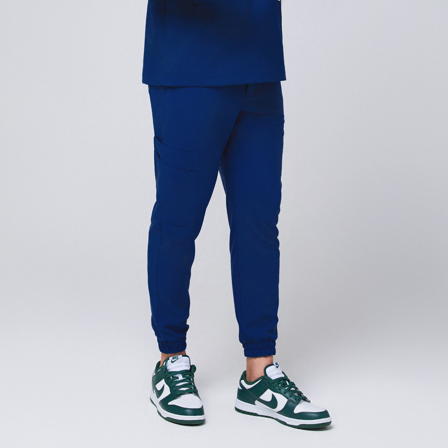 Image of Admiral Blue StretchFit Jogger Scrub Pants with tapered jogger fit, elastic cuffs, and side cargo pocket, made from flexible stretch fabric.
