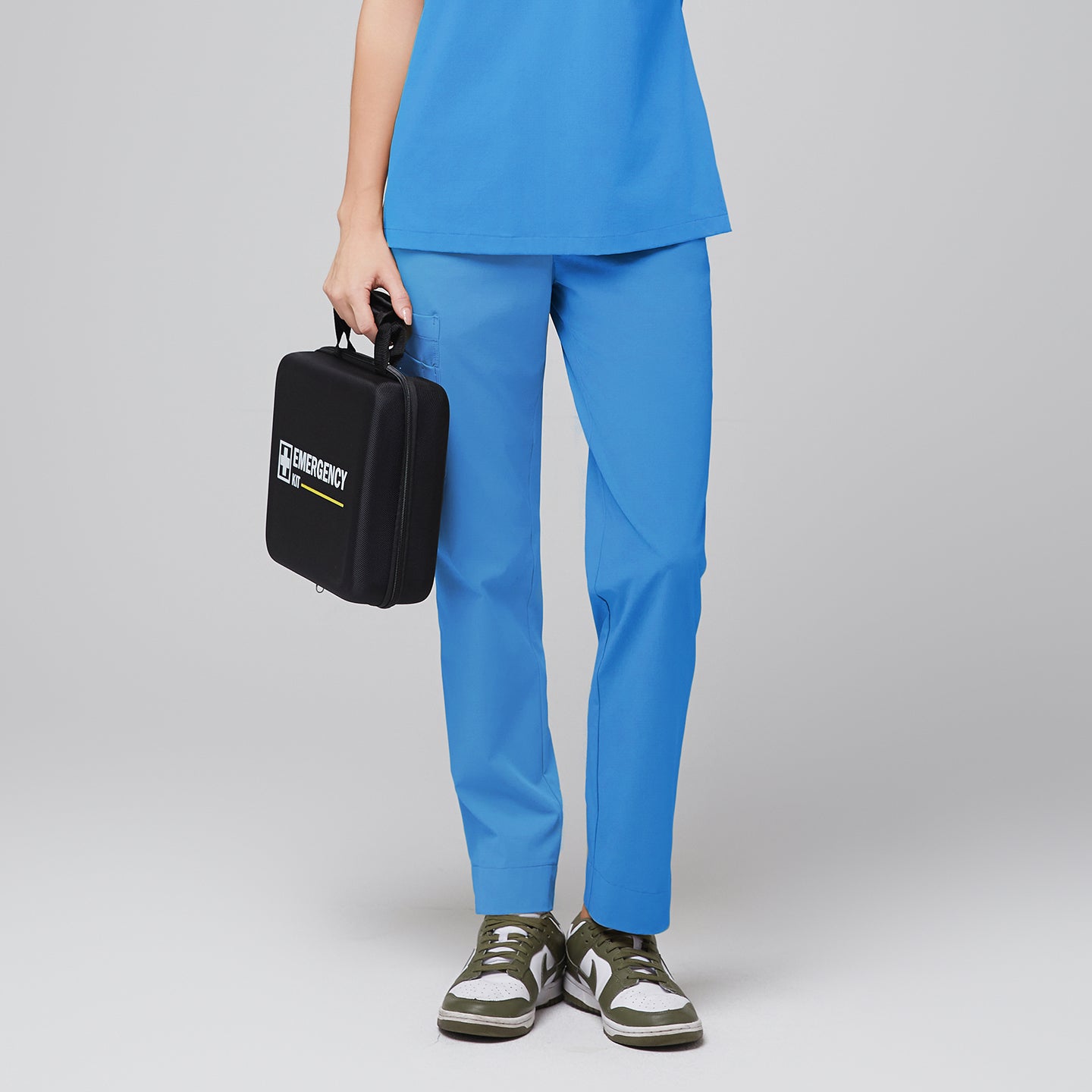Image of Front view of a woman modeling an aqua blue scrub top with matching aqua blue scrub pants with a split hem, featuring multiple pockets and breathable fabric for optimal comfort and functionality in healthcare settings,Aqua blue