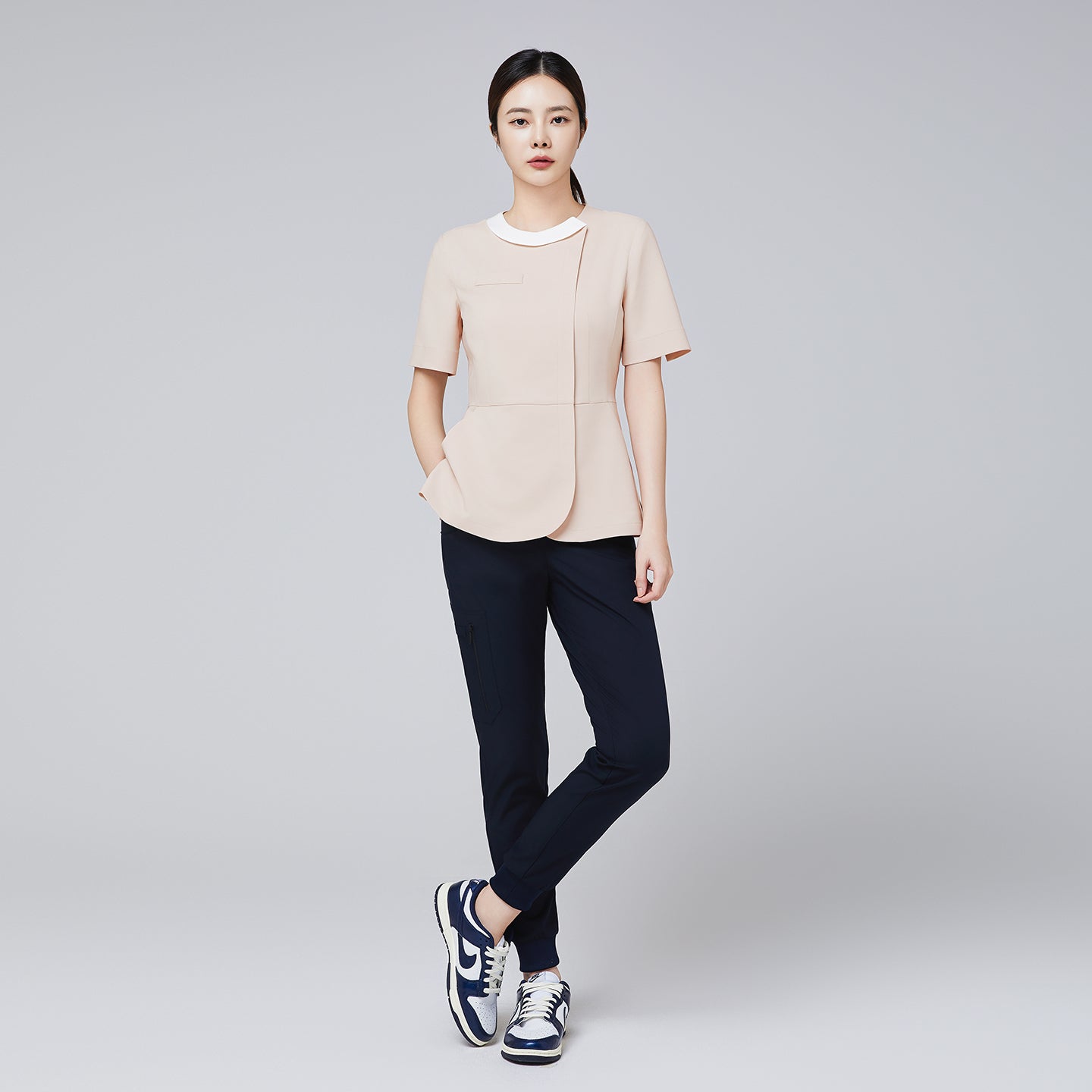Image of Full outfit featuring TUL NS-149 Women's Round Collar Scrub Top in Beige paired with navy pants, highlighting a modern color contrast.