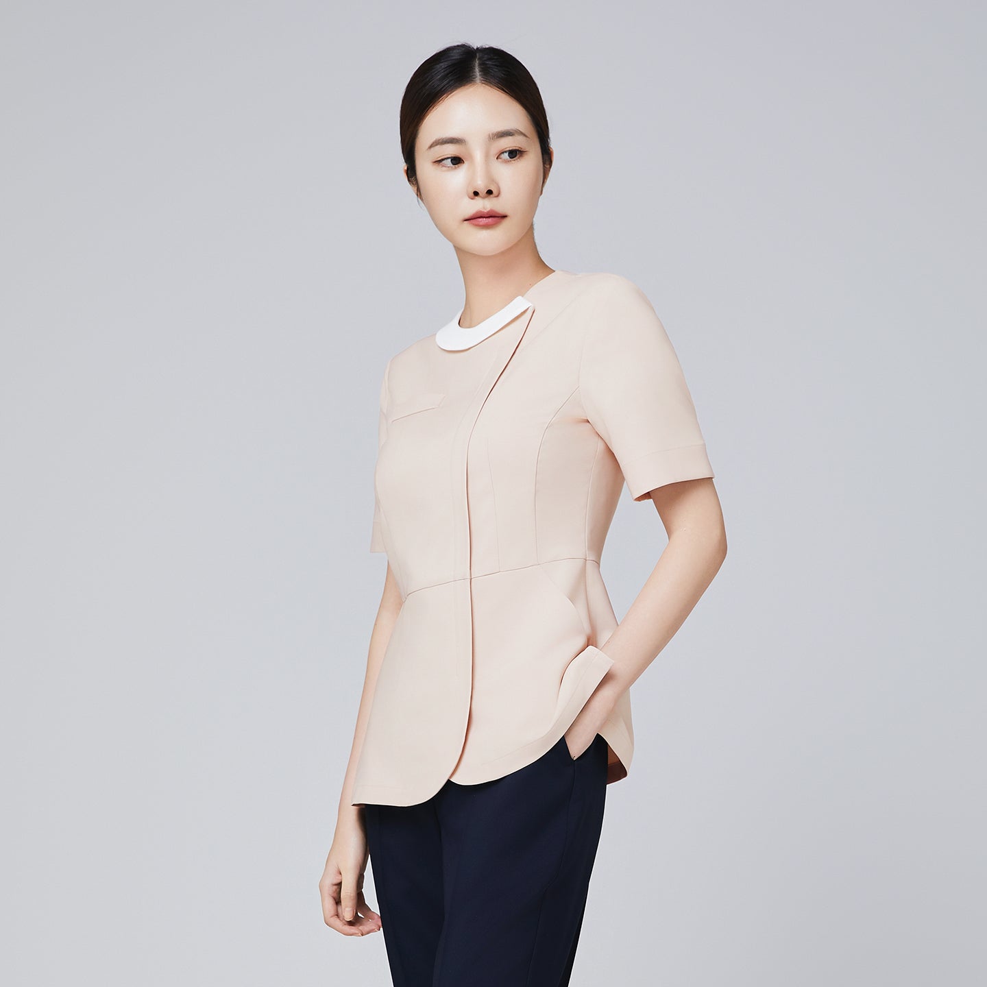 Image of Side view of TUL NS-149 Women's Beige scrub top, featuring a gently flared hem and subtle front seams for a tailored fit.