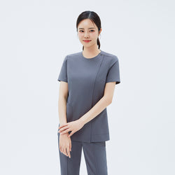 Image of Front view of TUL OS-212 Women's Dual Snap Front Zipper Scrub Top in Blue Gray, highlighting snap details at the shoulder and practical front pockets.