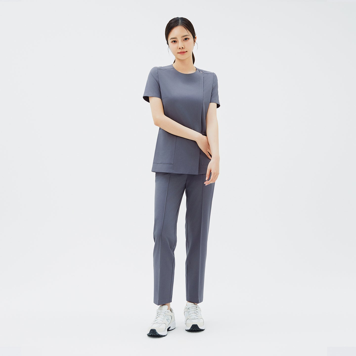 Image of Full-length shot of TUL OS-212 Blue Gray scrub top paired with matching pants, offering a cohesive and professional uniform look.