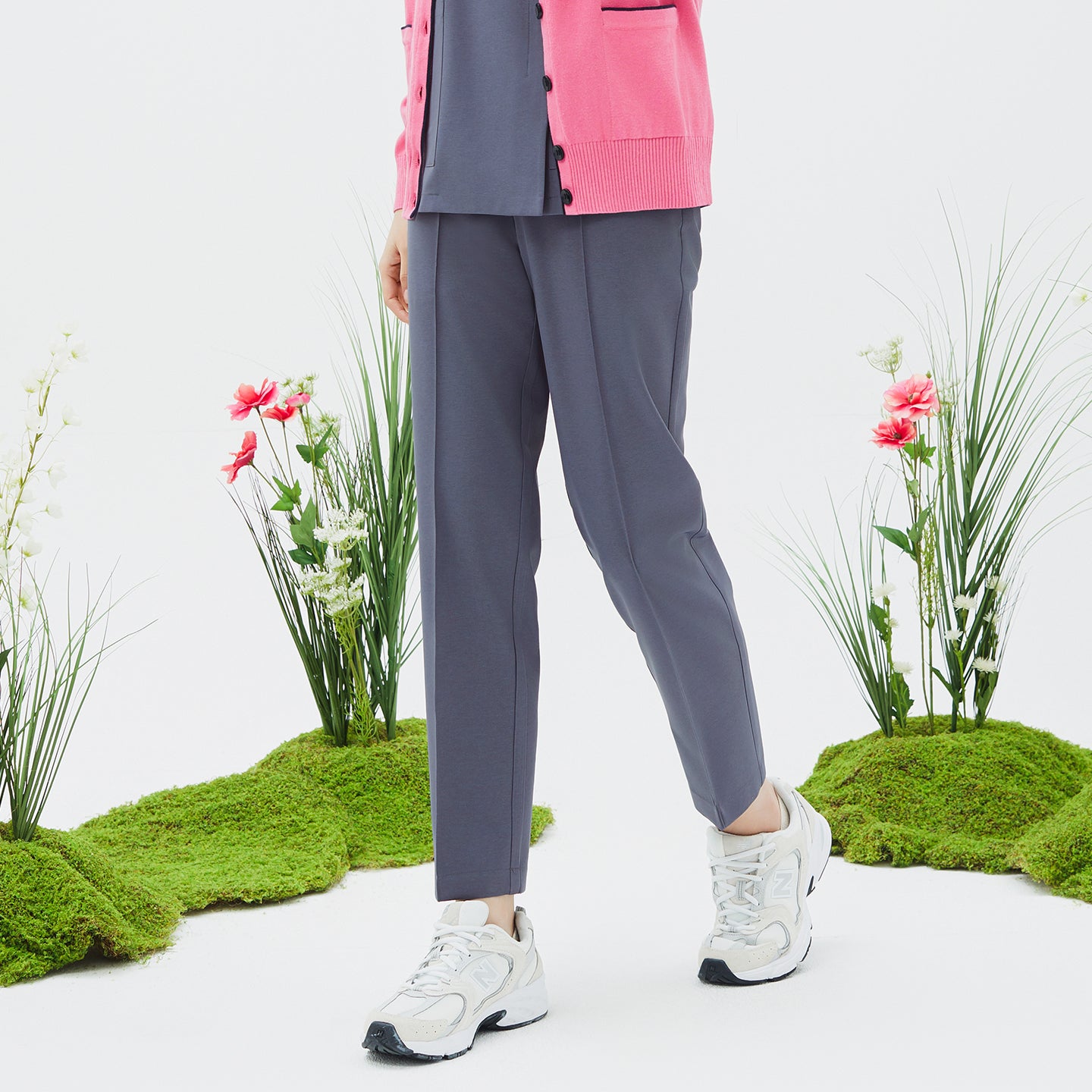 Model wearing TUL Women's Premium Banding Pants in Blue Gray with a pink cardigan, highlighting a modern, comfortable silhouette.