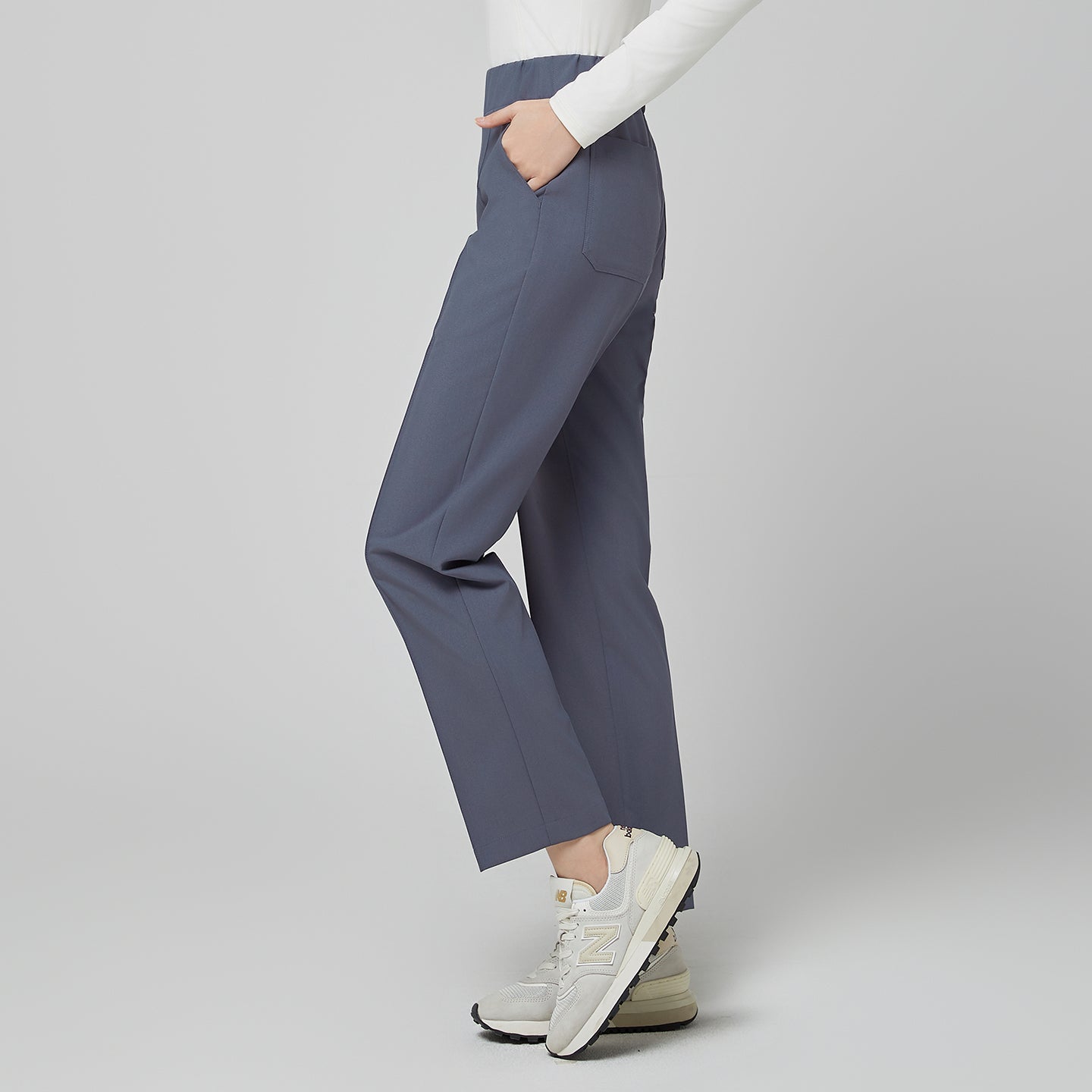 Image of Side angle of TUL Women's Premium Banding Pants in Blue Gray, showcasing the stretch fabric and discreet banding detail.