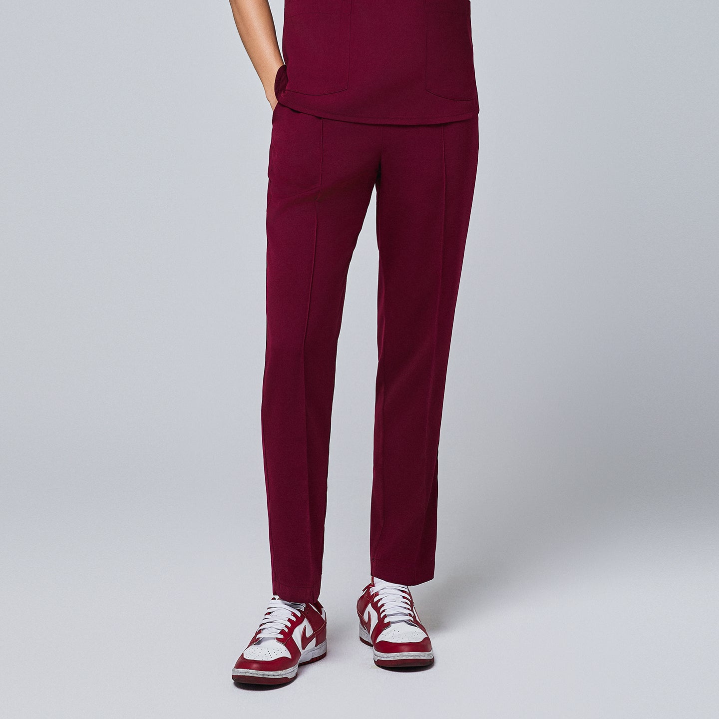 Image of Burgundy Line Banding Scrub Pants with straight slim fit and clean front seam detail, offering a modern and comfortable professional look.
