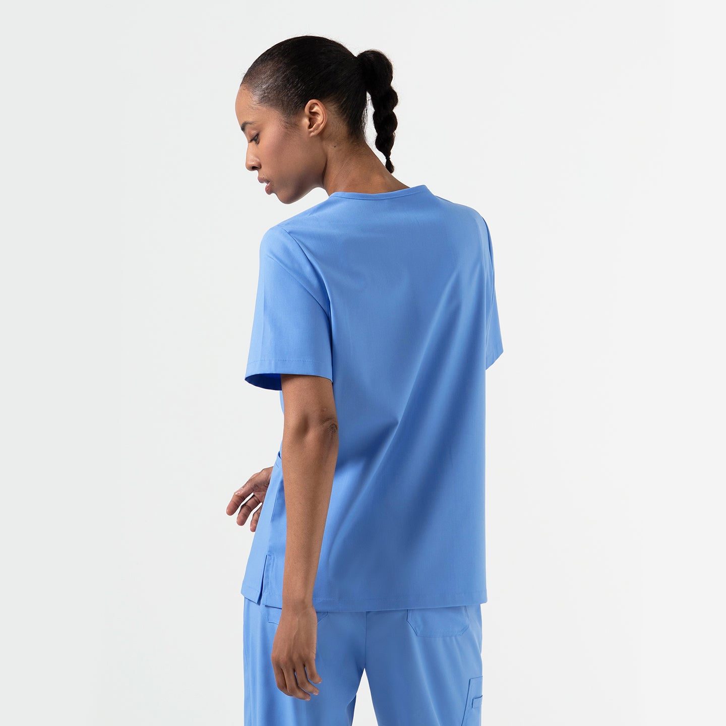 Ceil Blue double-pocket scrub top shown from the back, featuring short sleeves, a relaxed fit, and straight hem.