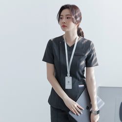 Image of Close-up of TUL OS-182 Women's scrub top in Charcoal Gray, with a V-neck design, front zipper, and short sleeves.