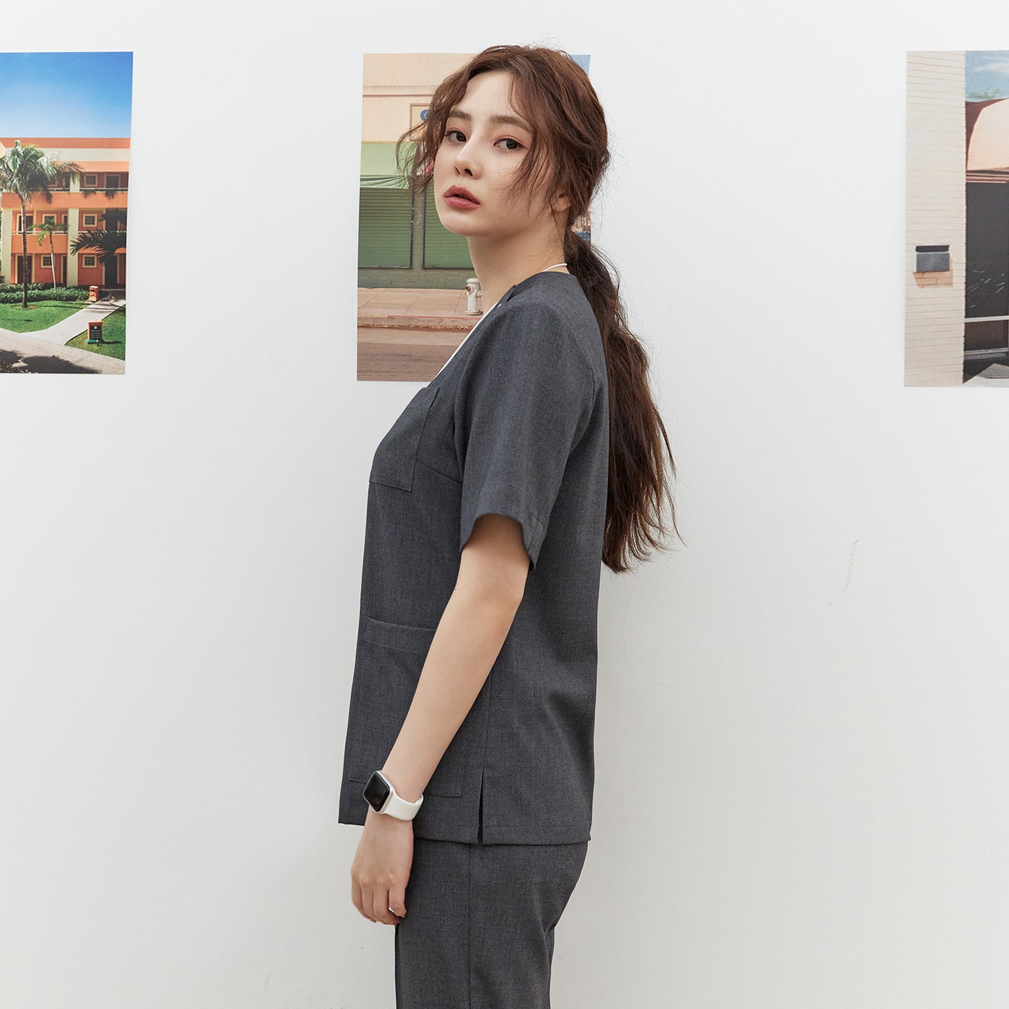 Side view of TUL OS-186 Charcoal Gray scrub top, highlighting a tailored fit and short sleeves.
