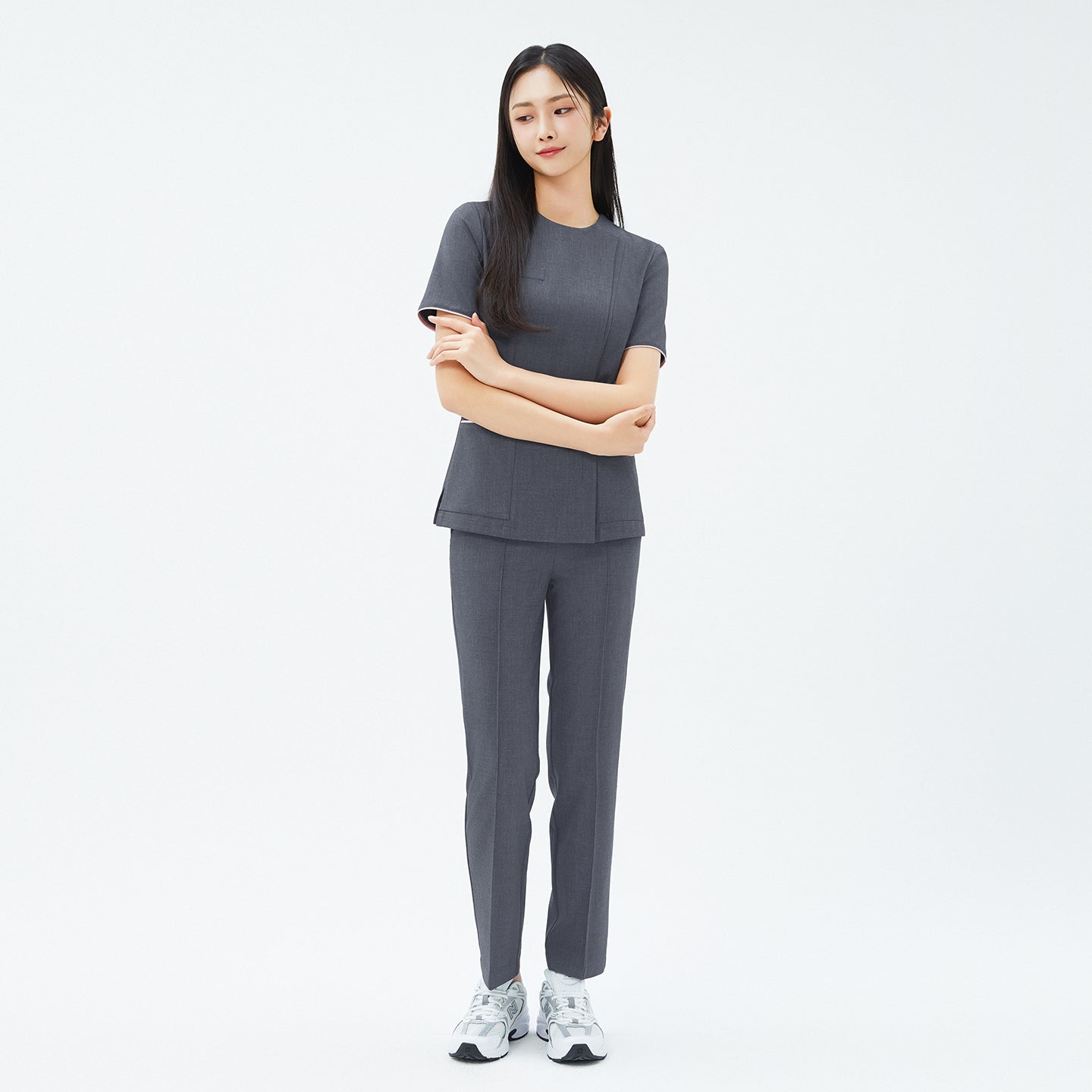 Model crossing arms in TUL Women's Premium Banding Pants in Chacoal Gray, emphasizing a polished silhouette and high-quality material.